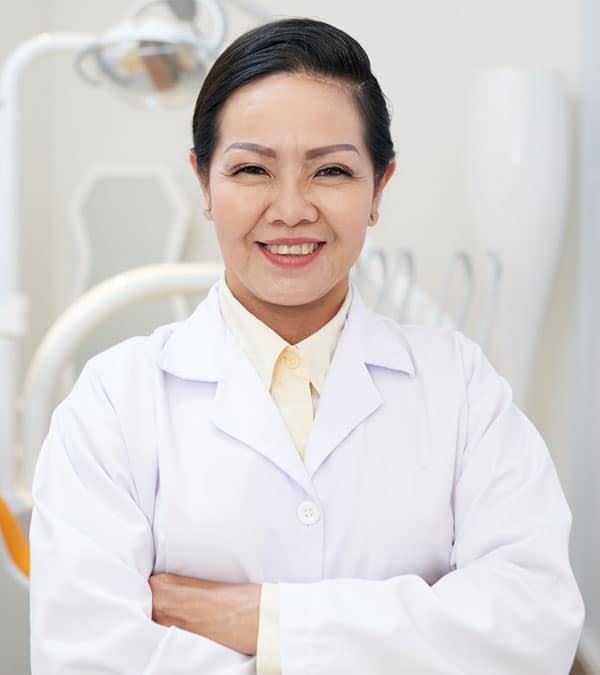 cheerful-ethnic-dentist-in-white-gown-NX8F3SB.jpg
